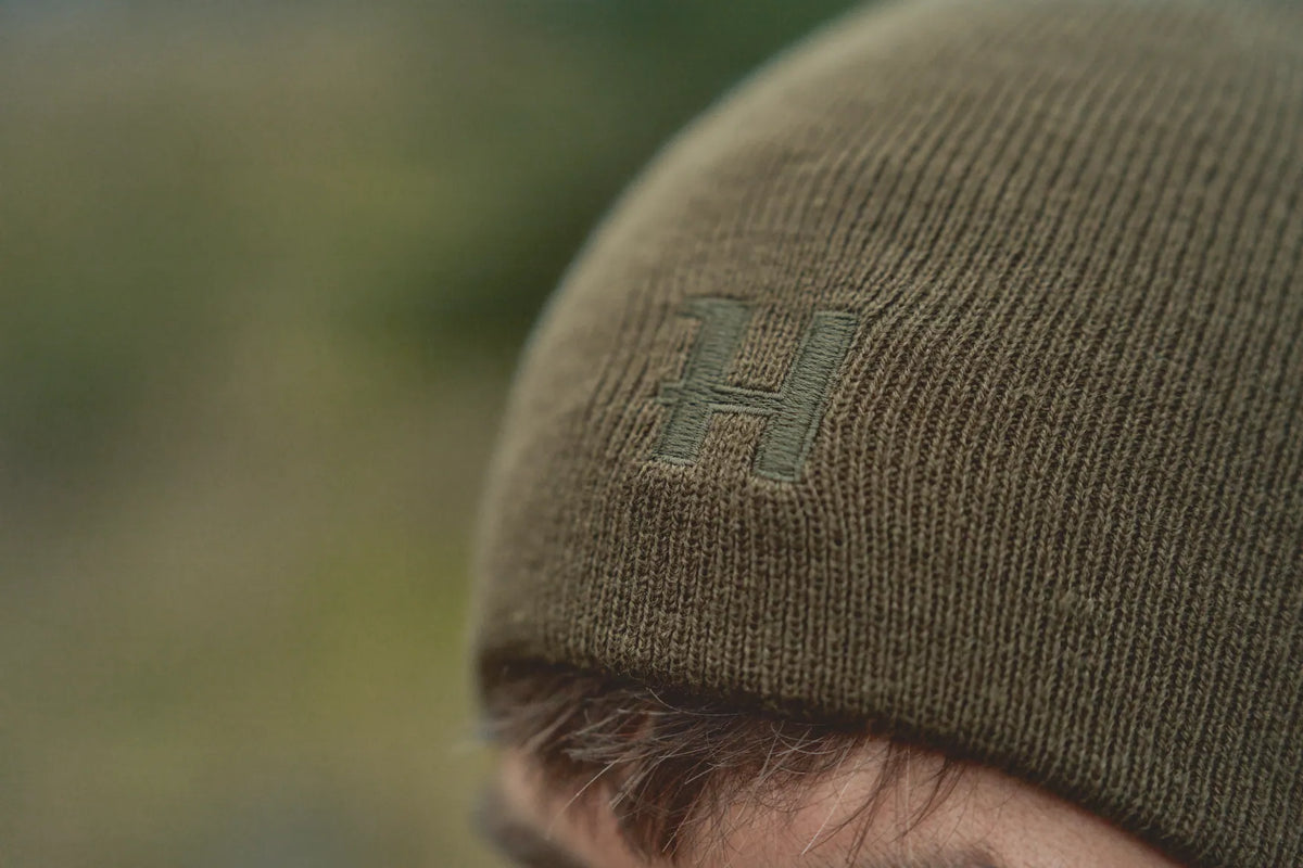 Härkila reversible beanie - Willow green/Orange